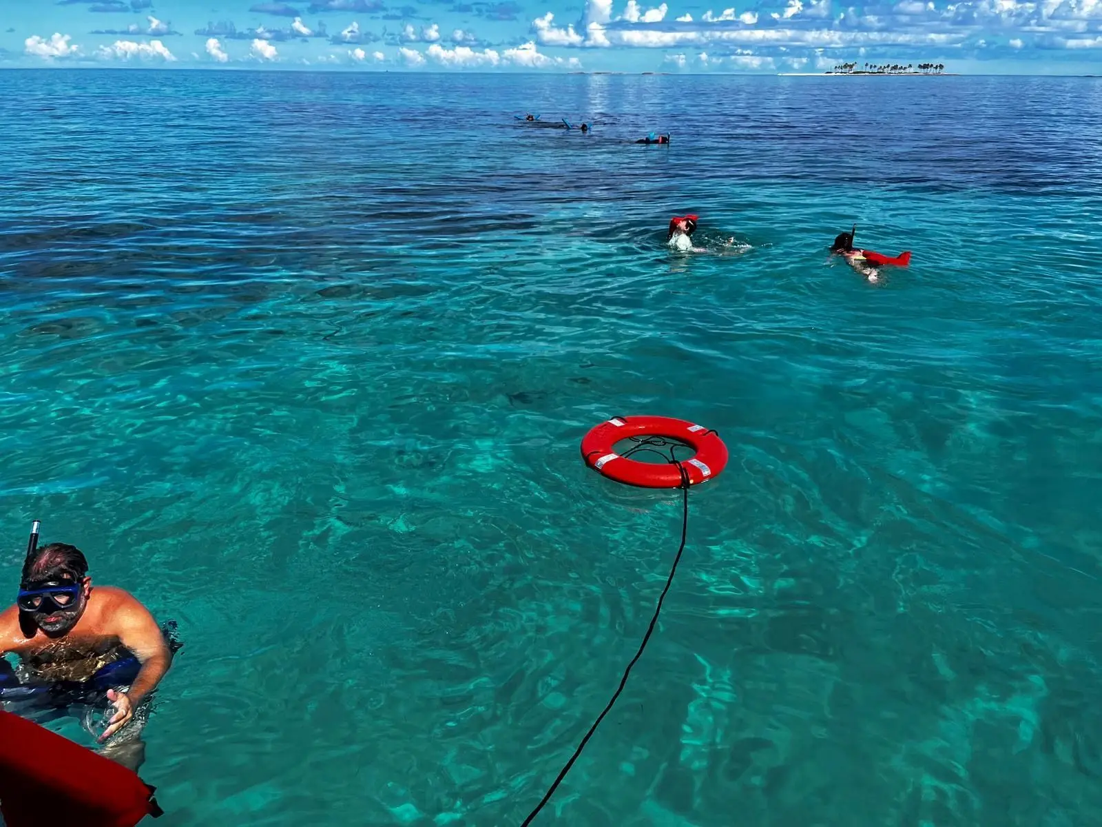 Beach day experience with water toys and snorkeling near Rose Island