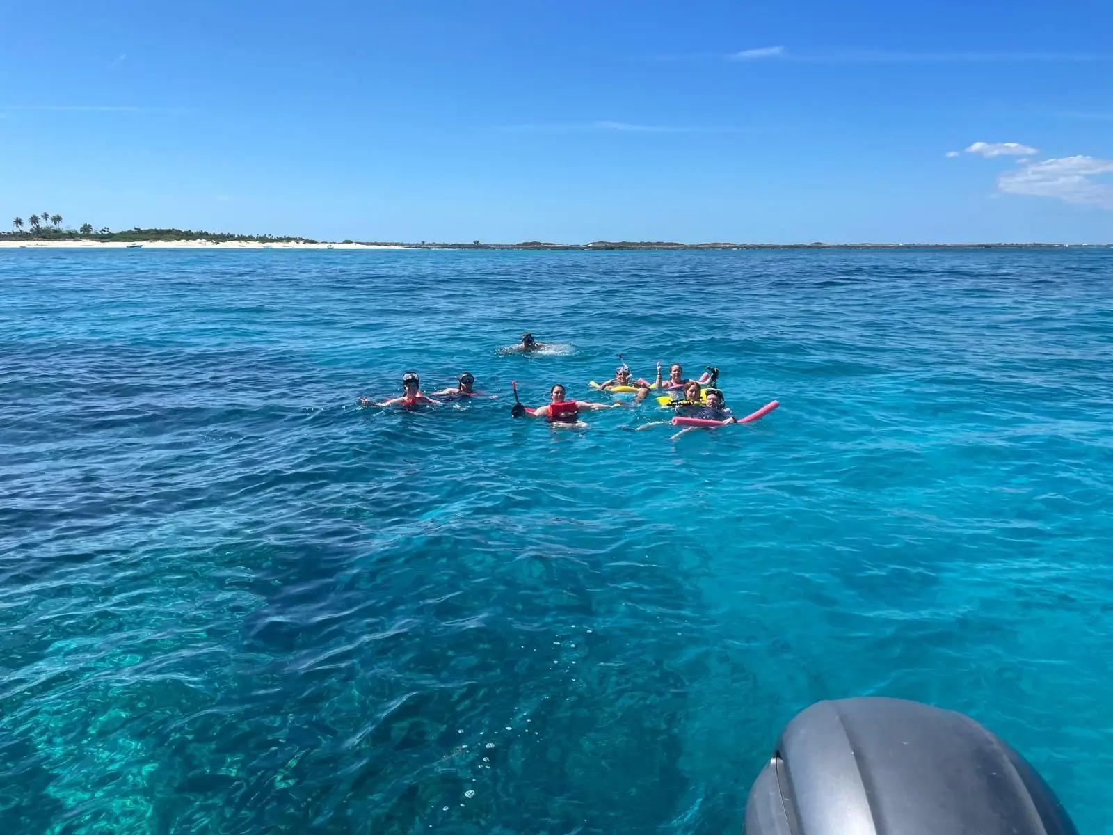 Beach day experience with water toys and snorkeling near Rose Island